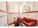 Retro bathroom featuring a red sink and toilet alongside classic white and red tile at 2 Elm St, Denver, CO 80220
