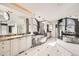 Bright and open bathroom has dual sinks, a soaking tub, and large windows at 2 Elm St, Denver, CO 80220