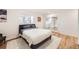 Bedroom featuring modern bed with plush white rug and sliding glass doors opening to the other rooms at 2 Elm St, Denver, CO 80220