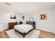 Cozy bedroom featuring a bed with neutral bedding and accent art; speakers in ceiling for entertainment at 2 Elm St, Denver, CO 80220