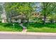 Charming home featuring lush landscaping, a curved walkway, and a welcoming facade at 2 Elm St, Denver, CO 80220