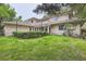 Spacious home exterior featuring lush lawn, mature trees, screened in porch, and ample outdoor space at 2 Elm St, Denver, CO 80220