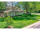 Well-maintained front yard with lush green grass and mature trees surrounding the home at 2 Elm St, Denver, CO 80220