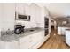 Bright kitchen boasts granite counters and stainless steel appliances at 2 Elm St, Denver, CO 80220