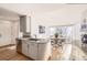 Bright kitchen with stainless steel appliances, granite countertops and a breakfast nook with large windows at 2 Elm St, Denver, CO 80220