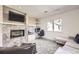 Cozy living room features a fireplace, built-in desk, and large window at 2 Elm St, Denver, CO 80220