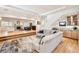 Bright open living room with hardwood floors, fireplace, wet bar, and comfortable sectional sofa at 2 Elm St, Denver, CO 80220