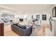 Open-concept living room with hardwood floors, modern furniture, and a fireplace feature at 2 Elm St, Denver, CO 80220