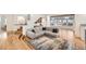 Open living room with hardwood floors, a comfortable sectional sofa and seamless transition to multiple living spaces at 2 Elm St, Denver, CO 80220