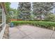Expansive concrete patio with beautiful landscaping and mature trees offering a serene outdoor living space at 2 Elm St, Denver, CO 80220