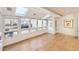 Sunroom with skylights and large windows overlooking the backyard patio, flooding the room with light at 2 Elm St, Denver, CO 80220