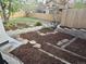 Landscaped backyard with mulch, stone accents, terraced levels, and wooden fence at 6948 W 70Th Ave, Arvada, CO 80003