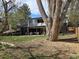 Large tree shades the backyard of this multi-story home with lots of windows at 6948 W 70Th Ave, Arvada, CO 80003