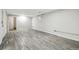 An open basement area features grey vinyl flooring and white walls and trim at 6948 W 70Th Ave, Arvada, CO 80003