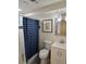 Cozy bathroom featuring a tiled shower with a stylish blue curtain, and updated fixtures at 6948 W 70Th Ave, Arvada, CO 80003