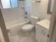 Updated bathroom with white subway tile, modern fixtures, and marble look flooring at 6948 W 70Th Ave, Arvada, CO 80003