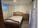 Bedroom featuring hardwood floors, a sliding closet door, and a window with natural light at 6948 W 70Th Ave, Arvada, CO 80003