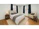 Cozy bedroom with neutral tones, plush bedding, hardwood floors, and large windows with natural light at 6948 W 70Th Ave, Arvada, CO 80003