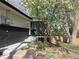 Charming home exterior with black brick accents, steps, and blooming tree at 6948 W 70Th Ave, Arvada, CO 80003