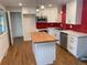 Modern kitchen featuring white cabinets, stainless steel appliances, and a butcher block island at 6948 W 70Th Ave, Arvada, CO 80003