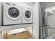 Laundry area featuring side-by-side washer and dryer with a stainless steel refrigerator at 6948 W 70Th Ave, Arvada, CO 80003