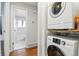 Laundry area with stacked washer and dryer, and access to a bright and clean bathroom at 6948 W 70Th Ave, Arvada, CO 80003