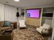 Cozy living room featuring built-in shelving, comfortable seating, and a decorative fireplace at 6948 W 70Th Ave, Arvada, CO 80003