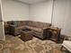 Comfortable living room featuring a sectional sofa, patterned rug, and side tables at 6948 W 70Th Ave, Arvada, CO 80003