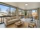 Open-concept living space with large windows, modern furniture, and views of the surrounding neighborhood at 6948 W 70Th Ave, Arvada, CO 80003