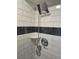 Modern shower featuring white subway tile with a rain shower head and handheld shower at 6948 W 70Th Ave, Arvada, CO 80003