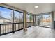 An indoor/outdoor sunroom with wood-look floors, full-length windows and views of the neighborhood at 6948 W 70Th Ave, Arvada, CO 80003