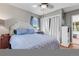 Cozy bedroom featuring a comfortable bed, hardwood floors, natural light, and closet space at 15205 W 43Rd Ave, Golden, CO 80403