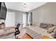 Functional bedroom with a daybed, hardwood floors, natural light, and a compact desk area at 15205 W 43Rd Ave, Golden, CO 80403