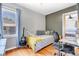Inviting bedroom with a daybed, desk, guitar, and natural light streaming through the window at 15205 W 43Rd Ave, Golden, CO 80403