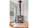 Corner view of rustic fireplace, window and decorative light blue curtains at 15205 W 43Rd Ave, Golden, CO 80403