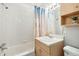 Bathroom with white tiles, vanity, and tub shower combo, providing a comfortable and functional space at 2500 S York St # 410, Denver, CO 80210