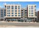 Contemporary mixed-use building with retail storefronts and residential units above, featuring large windows at 2500 S York St # 410, Denver, CO 80210