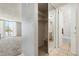 Hallway with closet offering access to the bathroom and a view of the living room at 2500 S York St # 410, Denver, CO 80210