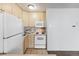 Modest kitchen with tile floors, light wood cabinets, white appliances, and ample counter space at 2500 S York St # 410, Denver, CO 80210