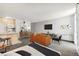 Bright living area showcases modern decor, a comfortable sofa, a work area, and an open layout with an accent wall at 2500 S York St # 410, Denver, CO 80210