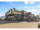 An urban restaurant with an outdoor patio and upper-level dining is adorned with vibrant signage at 2500 S York St # 410, Denver, CO 80210