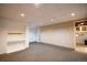 Spacious finished basement featuring neutral carpeting, recessed lighting, and ample storage space at 11205 Holly St, Thornton, CO 80233