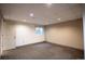Finished basement with carpet, window and door at 11205 Holly St, Thornton, CO 80233