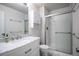 Bathroom with marble countertop, white cabinets, and a glass-enclosed shower at 11205 Holly St, Thornton, CO 80233