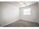 Bright bedroom with neutral carpet, a window, and a ceiling fan at 11205 Holly St, Thornton, CO 80233