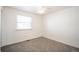 Inviting carpeted bedroom with a window, natural lighting, and a ceiling fan at 11205 Holly St, Thornton, CO 80233