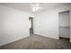 Spacious carpeted bedroom featuring an open closet, a door, and a ceiling fan at 11205 Holly St, Thornton, CO 80233