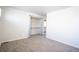 Well-lit carpeted bedroom featuring a closet, ample lighting, and an open floor plan at 11205 Holly St, Thornton, CO 80233