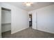 Carpeted bedroom with closet, ceiling fan and access to hallway at 11205 Holly St, Thornton, CO 80233