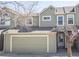 Inviting two-story townhome features a two-car garage, charming curb appeal, and tasteful neutral-toned siding at 11205 Holly St, Thornton, CO 80233